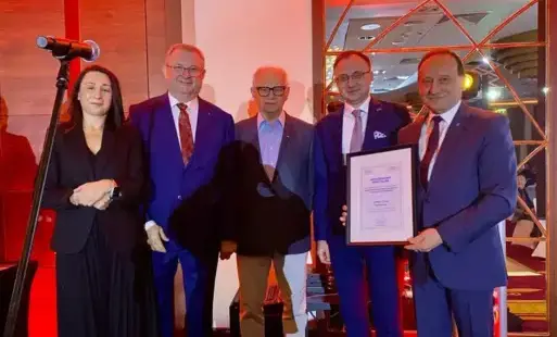 Sekretarz Gminy Marklowice pozuje do zdjecia z otrzymanym wyróznieniem specjalnym wraz z kilkoma innymi osobami